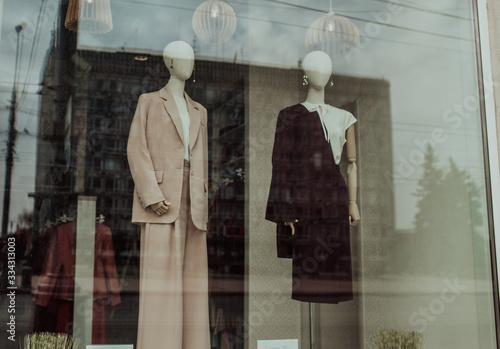 Mannequins standing in a shop window of a women's clothing store