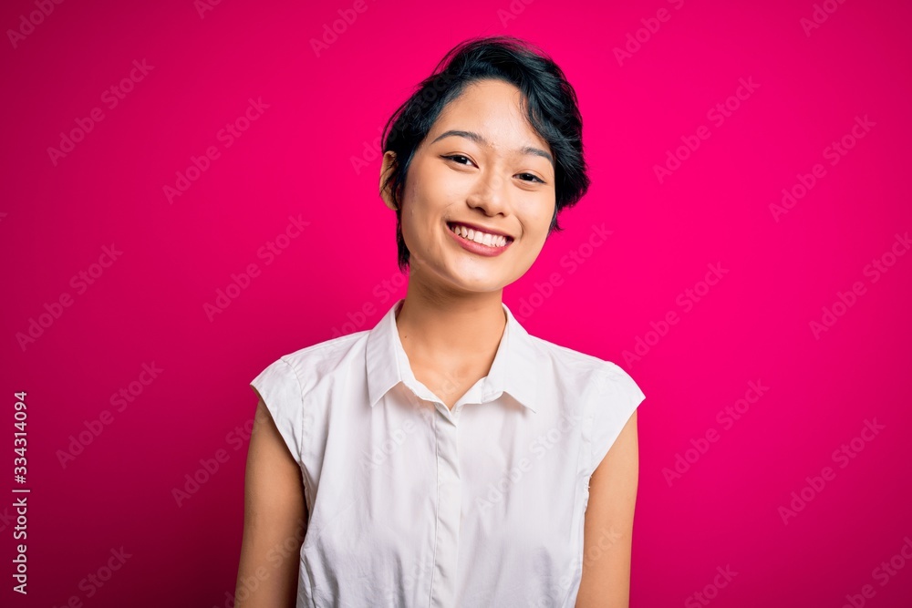 Young beautiful asian girl wearing casual summer shirt standing over isolated pink background with a happy and cool smile on face. Lucky person. Young beautiful asian girl wearing casual summer shirt standing over isolated pink background with a happy and cool smile on face. Lucky person.