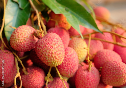 pink ripe lychee on wooden floor 