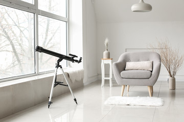 Interior of modern room with telescope