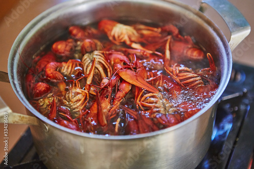Crawfish cooking boiling in pot with spices