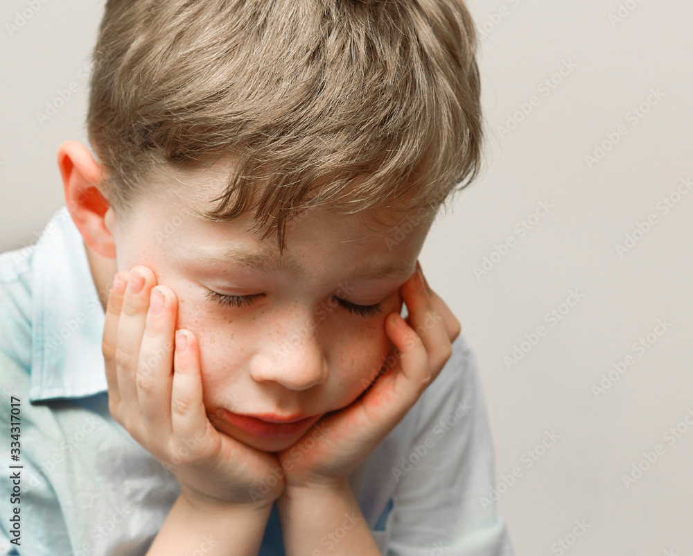 Sad school boy is overcome with mental stress Sad school boy is overcome with mental stress