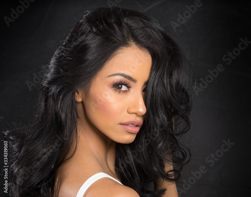 Beautiful young woman isolated against white background. photo