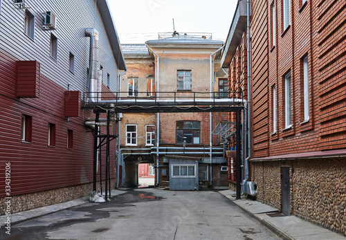 Vászonkép city alley with vintage and new buildings