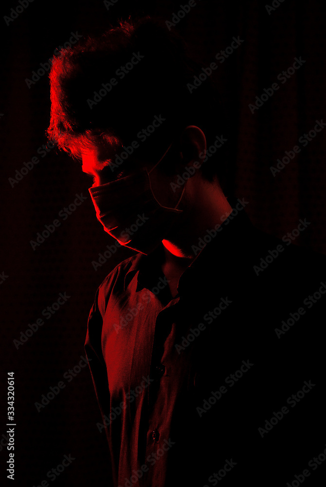 masked doctor in a dark room with red light masked doctor in a dark room with red light