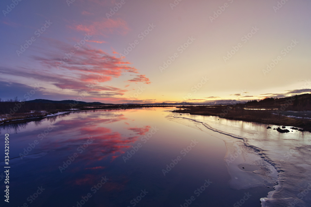 Fototapeta premium Lake in Thingvellir National Park, Iceland during sunset in wintertime. Rural, outdoor.