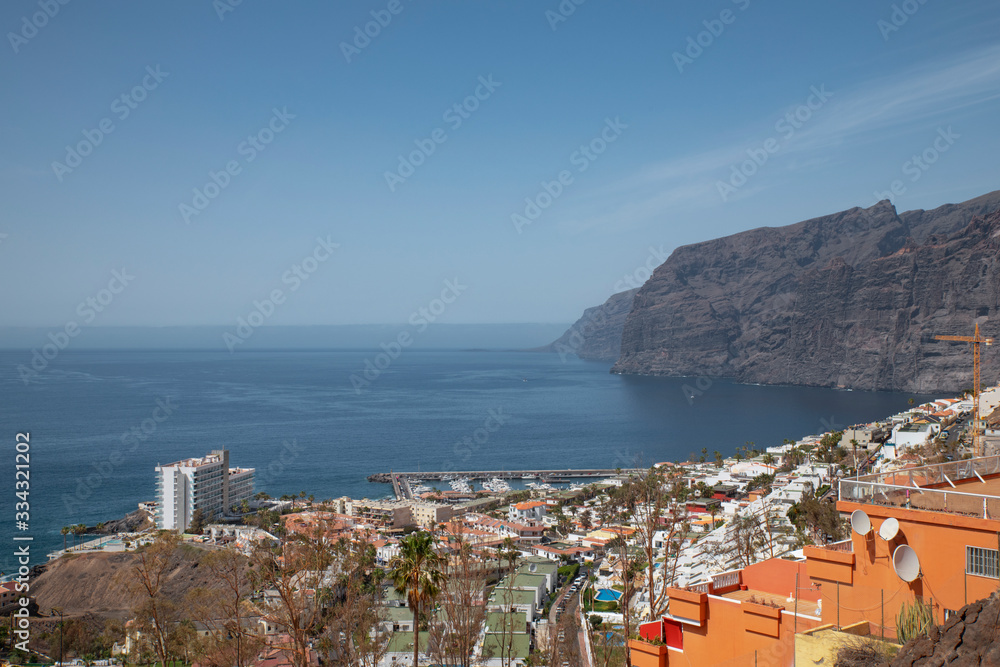 Acantillados de Los Gigantes or simply Los Gigantes, giant cliffs at the edge of Atlantic Ocean and the quaint village and resort as seen from an elevated viewpoint, Tenerife, Canary Islands, Spain