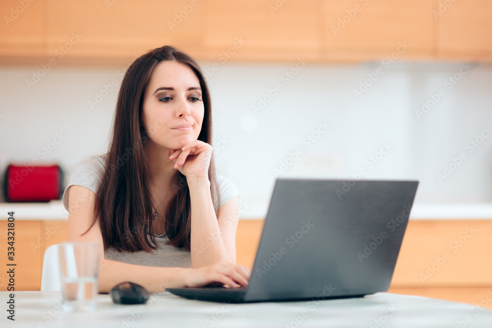 Worried Woman Reading the News at Home in the Kitchen Worried Woman Reading the News at Home in the Kitchen