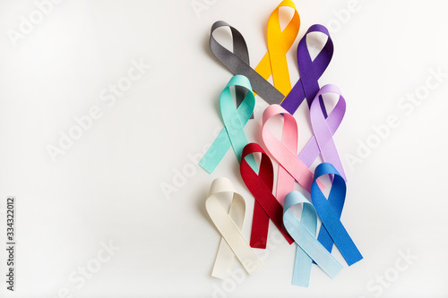 Multi colored cancer ribbons Proudly worn by patients, supporters and survivors for world cancer day. Bringing awareness to all types of cancer and copy space