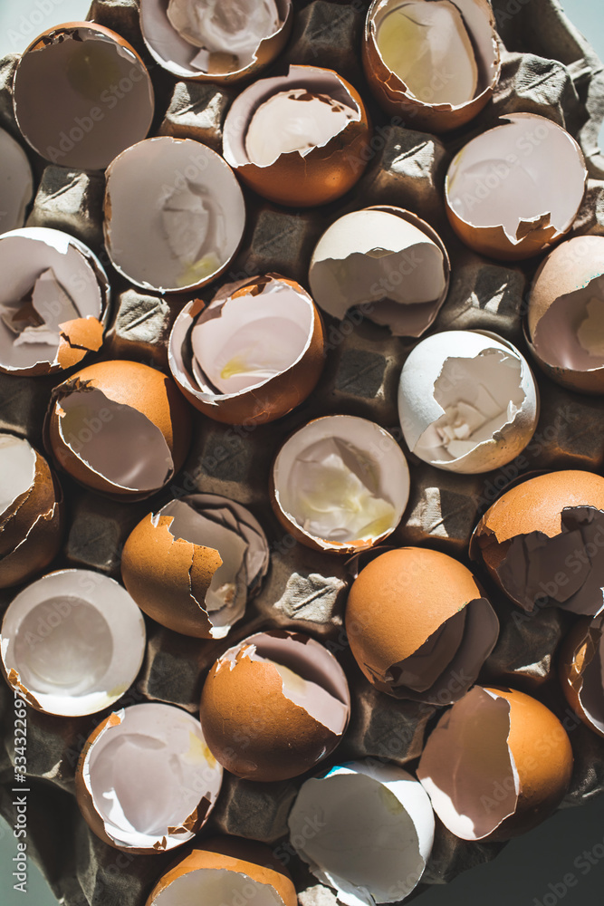 Texture of broken empty eggshell in carton box. View from above. Cooking on easter concept. Unusual photo of eggs. Texture of broken empty eggshell in carton box. View from above. Cooking on easter concept. Unusual photo of eggs.