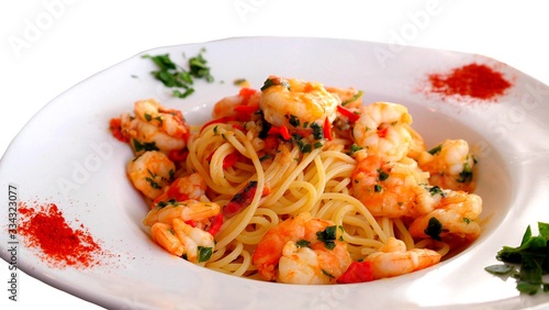 Studio photo of a mediterranean salad with spaghetti , shrimps and spices