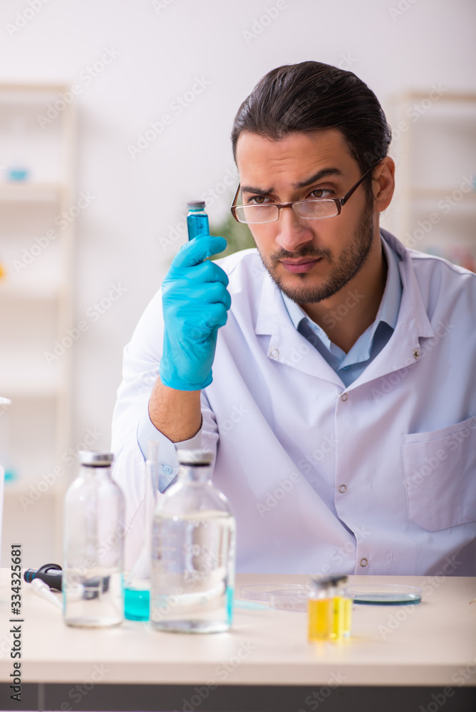 Young male chemist working in the lab Young male chemist working in the lab