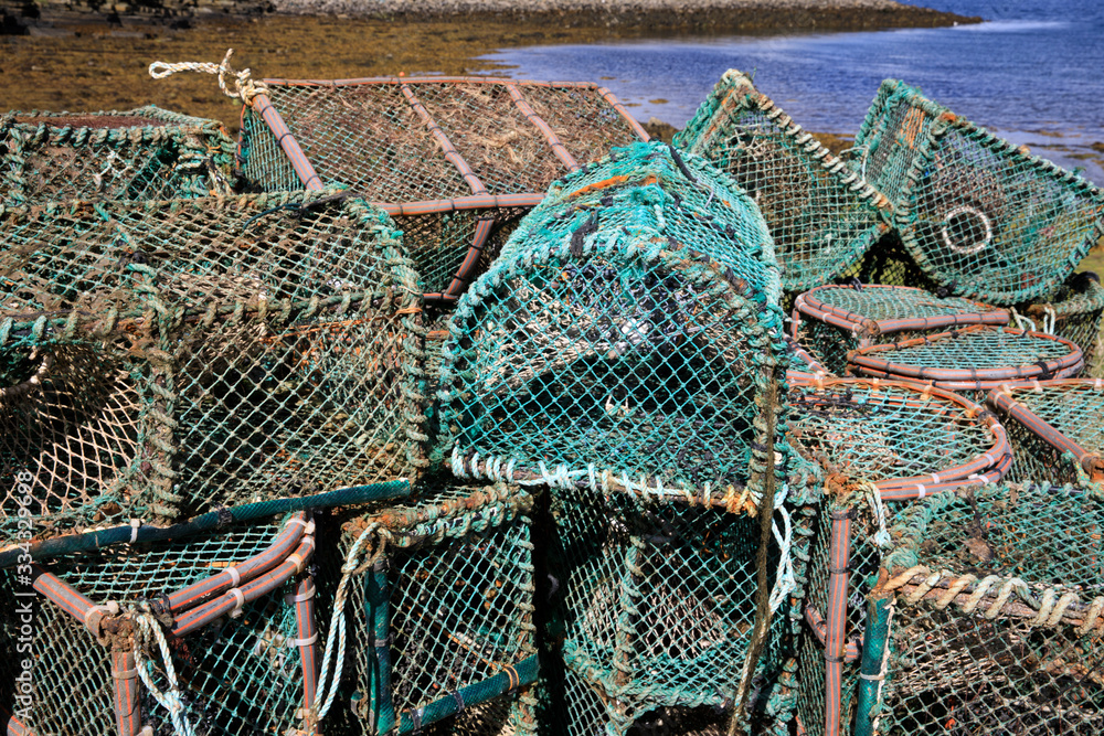 Orkney (Scotland), UK - August 10, 2018: Lobster and crab fishing pots piled in the port, Orkney, Scotland, Highlands, United Kingdom Orkney (Scotland), UK - August 10, 2018: Lobster and crab fishing pots piled in the port, Orkney, Scotland, Highlands, United Kingdom