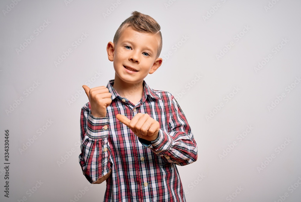 Young little caucasian kid with blue eyes wearing elegant shirt standing over isolated background Pointing to the back behind with hand and thumbs up, smiling confident Young little caucasian kid with blue eyes wearing elegant shirt standing over isolated background Pointing to the back behind with hand and thumbs up, smiling confident