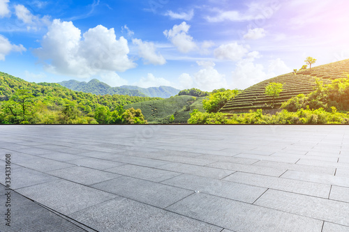 Empty square floor and green tea plantation nature landscape.