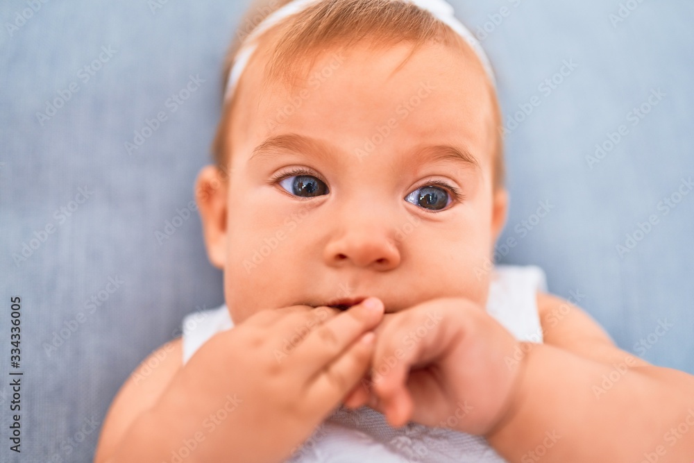 Adorable baby lying down on the sofa at home. Newborn relaxing and resting comfortable Adorable baby lying down on the sofa at home. Newborn relaxing and resting comfortable