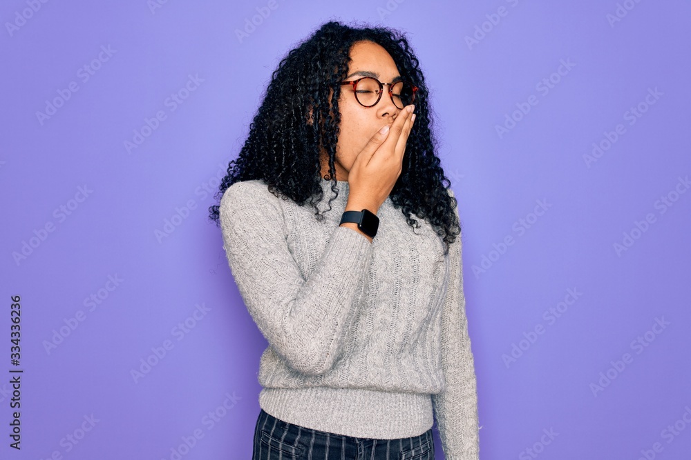 Young african american woman wearing casual sweater and glasses over purple background bored yawning tired covering mouth with hand. Restless and sleepiness. Young african american woman wearing casual sweater and glasses over purple background bored yawning tired covering mouth with hand. Restless and sleepiness.
