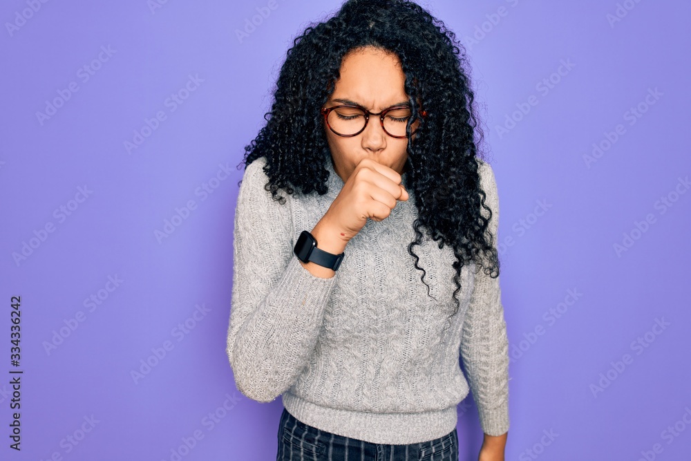 Young african american woman wearing casual sweater and glasses over purple background feeling unwell and coughing as symptom for cold or bronchitis. Health care concept. Young african american woman wearing casual sweater and glasses over purple background feeling unwell and coughing as symptom for cold or bronchitis. Health care concept.