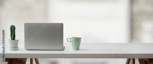 Wallpaper Mural Cropped shot of simple workspace with laptop, cactus pot, mug and copy space on white table Torontodigital.ca