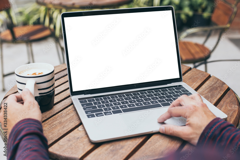 mockup image blank screen computer with white background for advertising text,hand man using laptop contact business search information on desk at coffee shop.marketing and creative design mockup image blank screen computer with white background for advertising text,hand man using laptop contact business search information on desk at coffee shop.marketing and creative design