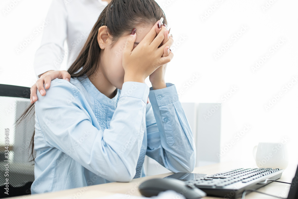 Asian young woman headache and sad depressed in working with friend Encouragement and consolation Asian young woman headache and sad depressed in working with friend Encouragement and consolation