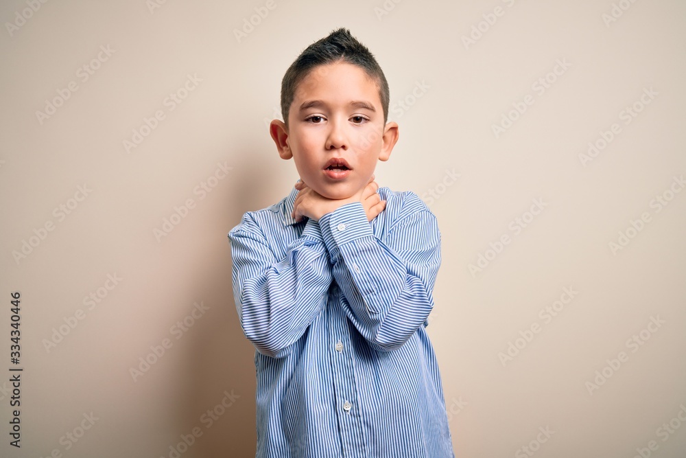 Young little boy kid wearing elegant shirt standing over isolated background shouting and suffocate because painful strangle. Health problem. Asphyxiate and suicide concept. Young little boy kid wearing elegant shirt standing over isolated background shouting and suffocate because painful strangle. Health problem. Asphyxiate and suicide concept.