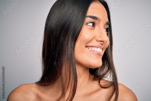 Close up of young beautiful woman with clear and pure skin. Perfect and clean skincare wearing natural makeup. Smiling happy looking fresh and healthy.