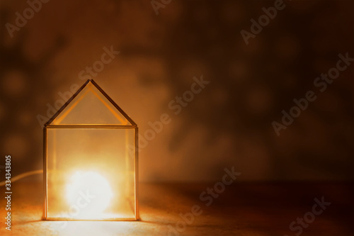 Photos Stay at home! The nightlight house is surrounded by the shadows of the bacteria covid-19