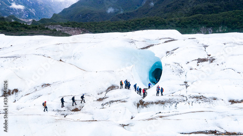 People Walking on the Glacier Exploradores in Front of the Big Ice Cave, near Rio Tranquilo in Chilean Patagonia, Chile (06.01.2020)