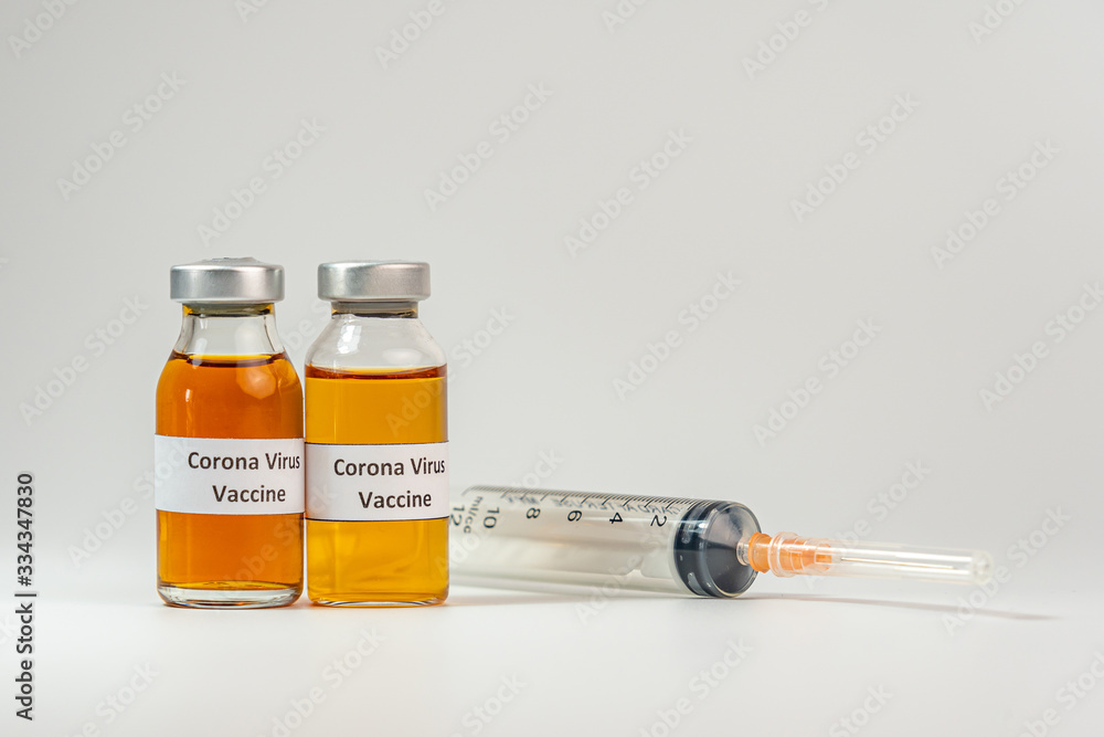 COVID-19 vaccine bottles and syringe injection on white background COVID-19 vaccine bottles and syringe injection on white background