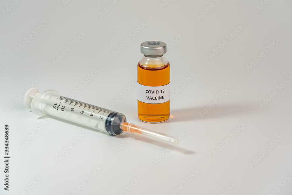 Coronavirus vaccine bottle on white background with medical syringe injection Coronavirus vaccine bottle on white background with medical syringe injection