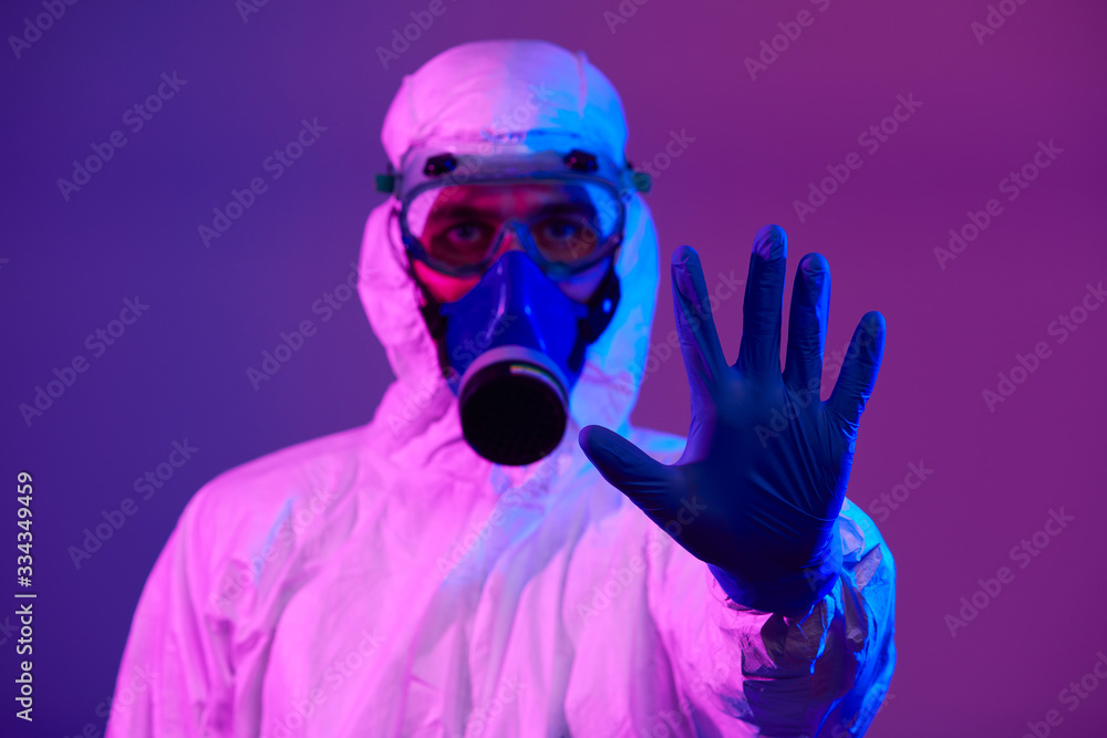 Doctor wearing protective biological suit and mask due to coronavirus