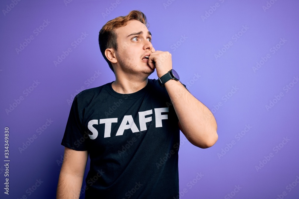 Young handsome redhead worker man wearing staff t-shirt uniform over purple background looking stressed and nervous with hands on mouth biting nails. Anxiety problem. Young handsome redhead worker man wearing staff t-shirt uniform over purple background looking stressed and nervous with hands on mouth biting nails. Anxiety problem.