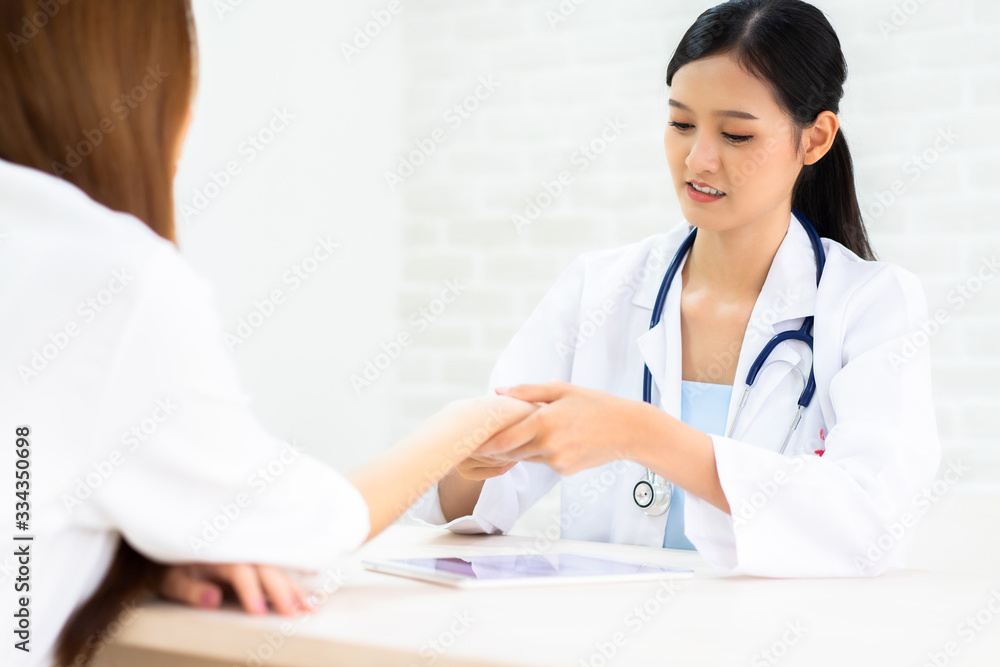 Female doctor talking to patient.Doctor and patient discussing something while sitting at the table . Medicine and health care concept. Doctor and patient Female doctor talking to patient.Doctor and patient discussing something while sitting at the table . Medicine and health care concept. Doctor and patient