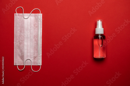 Medical equipment background. Protective masks sanitizer gel and lab gloves on red. Coronavirus disease. 2019-nCoV. WUHAN corona virus concept. Medical protective shielding bandage photo