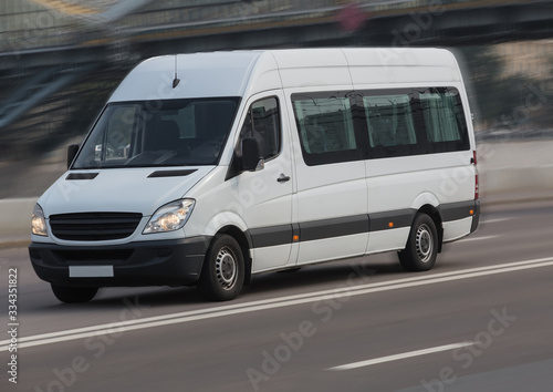 Minibus moves on a city street.