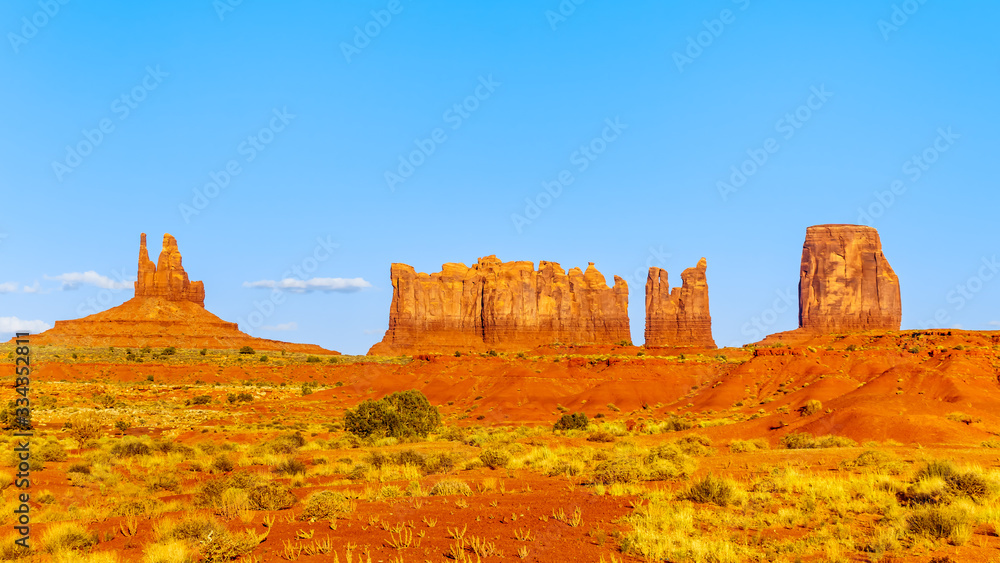 The sandstone formations of Mitten Buttes and Cly Butte in the desert landscape of Monument Valley Navajo Tribal Park in southern Utah, United States The sandstone formations of Mitten Buttes and Cly Butte in the desert landscape of Monument Valley Navajo Tribal Park in southern Utah, United States