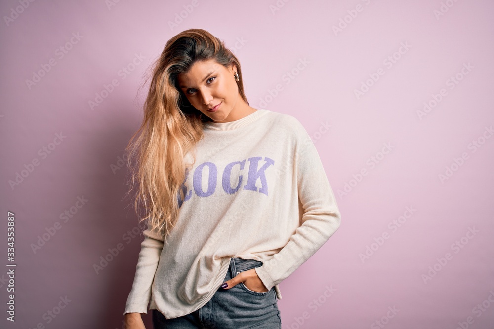 Young beautiful woman wearing fashion urban clothes, model wearing casual street style standing over pink background Young beautiful woman wearing fashion urban clothes, model wearing casual street style standing over pink background