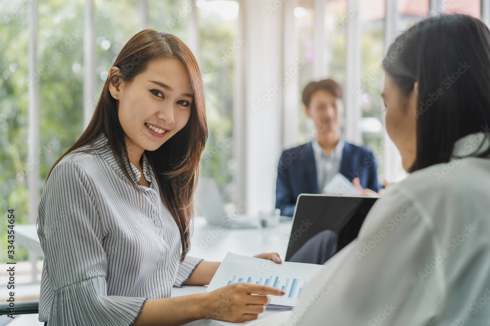 finance consultancy business concept. Happy young female financial advisor talking to client and showing report paper of funds investment to customer. finance consultancy business concept. Happy young female financial advisor talking to client and showing report paper of funds investment to customer.