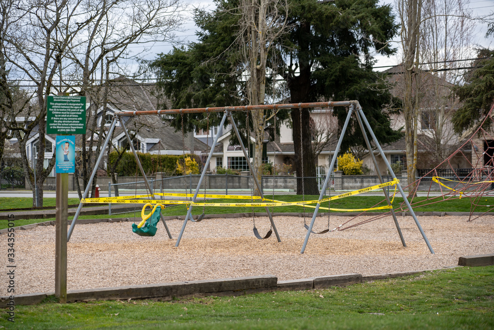 Police caution tape closing a children playground swing