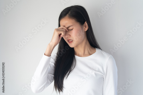 young asian women have a headaches from migraine isolated on white background.