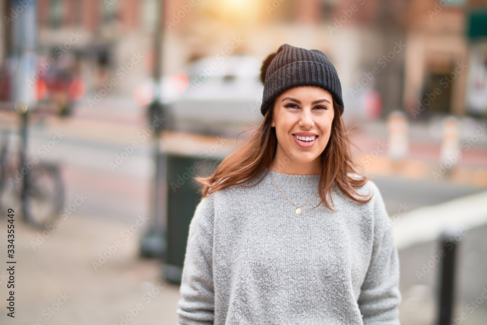Young beautiful woman smiling happy and confident. Standing with smile on face walking at the city Young beautiful woman smiling happy and confident. Standing with smile on face walking at the city