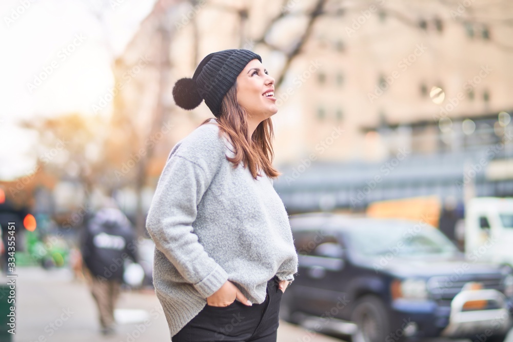 Young beautiful woman smiling happy and confident. Standing with smile on face walking at the city