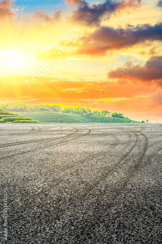 Race track road and green tea plantation nature landscape at sunset.