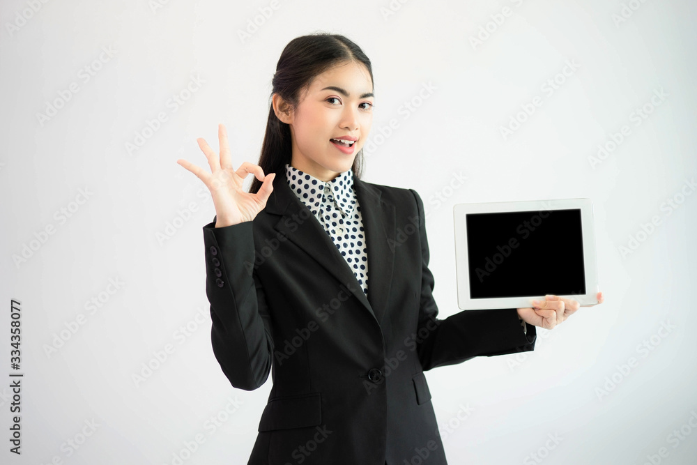 Asian businesswoman holding tablet present isolated on white background Asian businesswoman holding tablet present isolated on white background