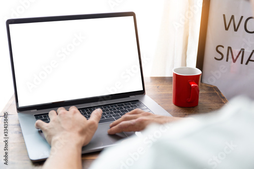 computer mockup image blank screen with white background for advertising text,hand woman using laptop contact business search information on desk at coffee shop.marketing and creative design