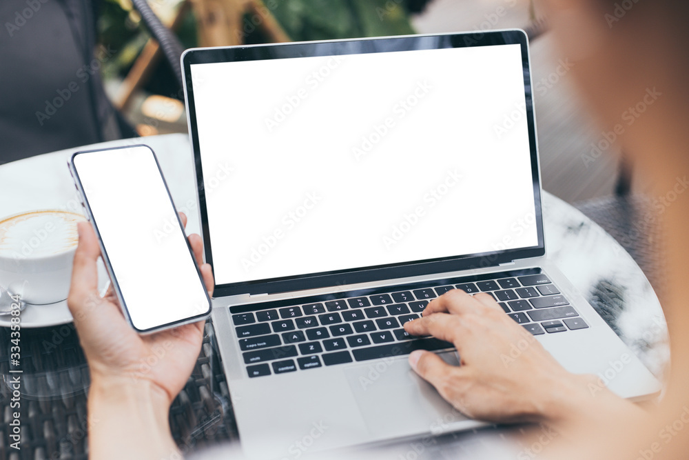computer,cell phone mockup image blank screen with white background for advertising text,hand woman using laptop texting mobile contact business search information on desk in cafe.marketing,design computer,cell phone mockup image blank screen with white background for advertising text,hand woman using laptop texting mobile contact business search information on desk in cafe.marketing,design