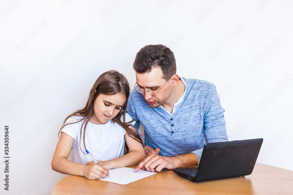 dad and daughter learn via the Internet, remote learning, family help, mom, relatives, time of quarantine and vacation, self-isolation, Skype, use of technology dad and daughter learn via the Internet, remote learning, family help, mom, relatives, time of quarantine and vacation, self-isolation, Skype, use of technology