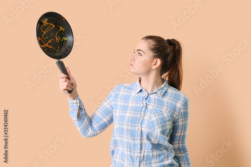 Woman with dirty frying pan...