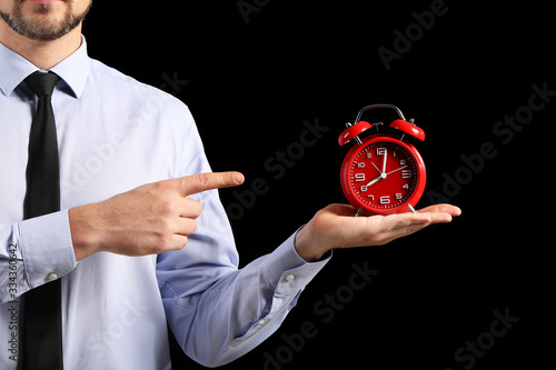 Businessman with alarm cloc...
